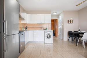 a kitchen with a washing machine and a table at Casa Weimar in Costa Calma +21 photos