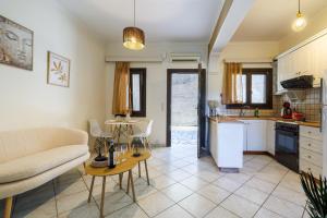 a kitchen and living room with a couch and a table at Breathing Apartment in Virós +12 photos