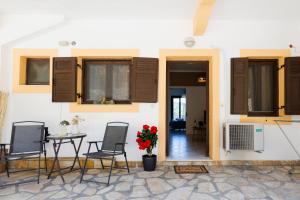 a patio with chairs and a table in front of a building at Breathing Apartment in Virós