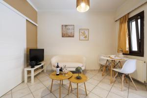 a living room with a tv and a table and chairs at Breathing Apartment in Virós