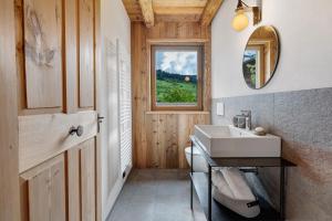 a bathroom with a sink and a window at Wellness Chalet Samer in Sarntal +36 photos