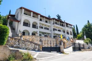 a large white building on a stone wall at Breathing Apartment in Virós