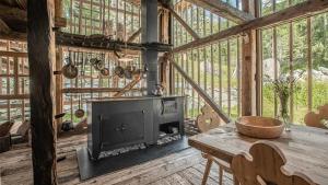 a living room with a fireplace in a wooden house at Tannhäuser Mountain Chalet in Predoi