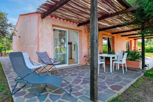 a patio with chairs and a table in front of a house at Stazzu Gallurese in Olbia