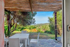 a table and chairs on a patio with a view at Stazzu Gallurese in Olbia