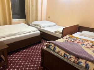 a room with two beds and a table at Manakamana hotel in Pāti Bhanjyāng
