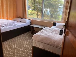 a small room with two beds and a window at Manakamana hotel in Pāti Bhanjyāng