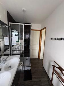 a bathroom with a white sink and a shower at Chambres D'hôtes Mongarny Cancale in Cancale +42 photos