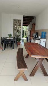 a wooden table in the middle of a kitchen at Casa da Mari in Caucaia