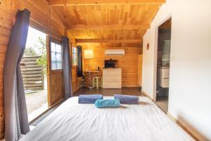 a room with a bed with two blue pillows on it at Le Chalet De La Plage in Coti-Chiavari +72 photos