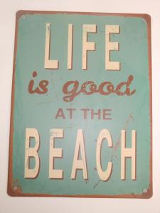 a sign that reads life is good at the beach at Casa Io in Mindelo