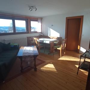 a living room with a couch and a table at Haus Fehrenbach in Sankt Märgen