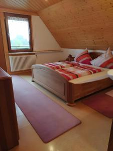a bedroom with a large bed in a attic at Haus Fehrenbach in Sankt Märgen
