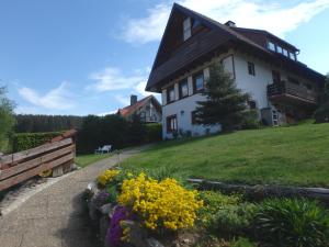 a house on top of a hill with flowers at Haus Fehrenbach in Sankt Märgen