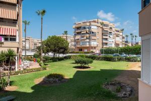 a park in front of a large apartment building at Estudio Bloque 90 in Torrox