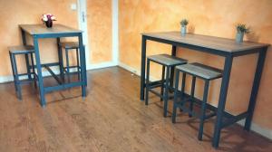 two tables and two stools in a room at Au Nid Douillet in Bourges +13 photos