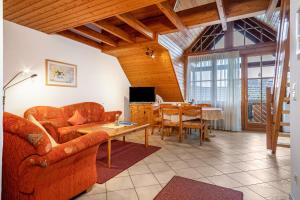 a living room with a couch and a table at Ferienhaus Behler in Kressbronn am Bodensee
