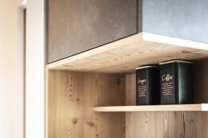 two books on a wooden shelf in a room at Oberplunerhof Luxury Chalet Woods in Chienes