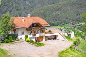 an aerial view of a house in the mountains at Oberplunerhof Luxury Chalet Woods in Chienes
