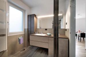 a bathroom with a sink and a large mirror at Casa Andrea in Gera Lario