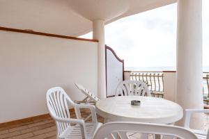 a white table and chairs on a balcony at Appartamento D - Le Terrazze in Ribera