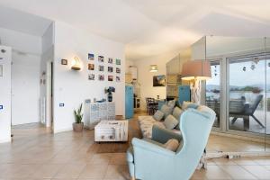 a living room with a couch and a table at Attico con terrazza a Viareggio in Viareggio