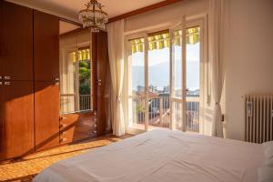 a bedroom with a bed and a large window at Verbania Panorama Lago in Verbania
