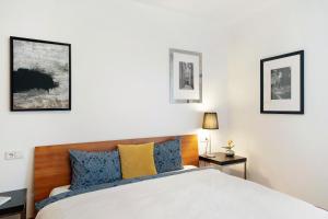 a bedroom with a bed with blue and yellow pillows at Kati´s Haus in San Pancrazio dʼUltimo