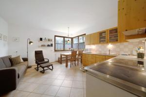 a kitchen and living room with a couch and a table at Kati´s Haus in San Pancrazio dʼUltimo