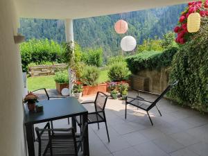 a patio with a table and chairs and a view at Kati´s Haus in San Pancrazio dʼUltimo