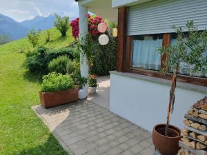 a house with potted plants next to a window at Kati´s Haus in San Pancrazio dʼUltimo +8 photos
