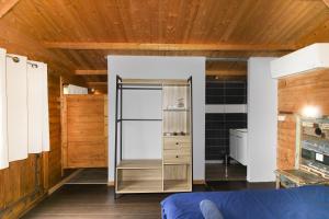 a room with a refrigerator and wooden walls at Le Chalet De La Plage in Coti-Chiavari