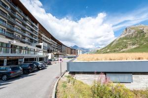 a street with cars parked in front of a building at Shamrock 2B in Tignes