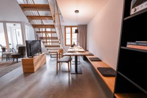 a dining room with a table and a living room at 4 Personen Apartment 47 in Überlingen