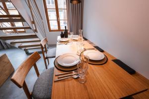 a wooden table with plates and wine glasses on it at 4 Personen Apartment 47 in Überlingen +16 photos