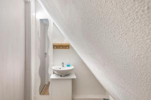 a bathroom with a sink in the middle of a staircase at Ferienhaus Feußner in Lauterbach +18 photos