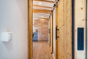 a hallway with a door leading to a kitchen at Alpenchalet zum Hirsch in Aschau +12 photos
