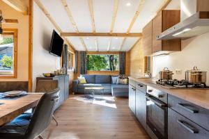 a kitchen and living room in a tiny house at Alpenchalet zum Hirsch in Aschau
