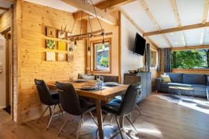 a dining room and living room with a table and chairs at Alpenchalet zum Hirsch in Aschau