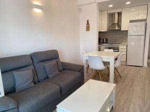 a living room with a couch and a table and a kitchen at Montiro in L'Escala