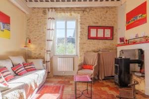 a bedroom with a bed and a tv and a window at Laho - Chambre d'hôte in Lagorce