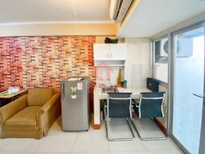 a kitchen with a couch and chairs in a room at Cozy 2BR Bintaro Park View Pool in Jakarta