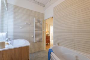a bathroom with a tub and a sink at Laho - Chambre d'hôte in Lagorce +26 photos