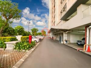 a parking lot with cars parked outside of a building at Cozy 2BR Bintaro Park View Pool in Jakarta