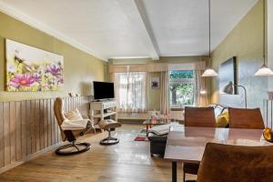 a living room with a table and chairs at Ferienhof Harrsen in Pellworm
