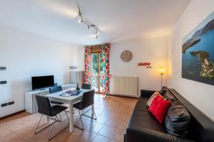 a living room with a couch and a table at Villa Bornico Margherita in Toscolano Maderno