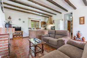 a living room with a couch and a table at Las Gallinas Cottage Orgiva in Órgiva