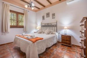 a bedroom with a large bed in a room at Las Gallinas Cottage Orgiva in Órgiva +18 photos