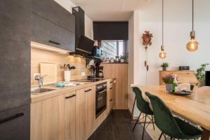 a kitchen with wooden cabinets and a wooden counter top at Heimelig im Hirschen App 117 in Schönwald