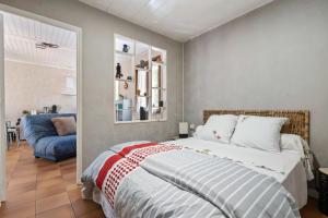 a bedroom with a bed and a blue couch at studio maupas in Vienne